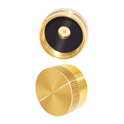 Gold metal cap with black center on a white background
